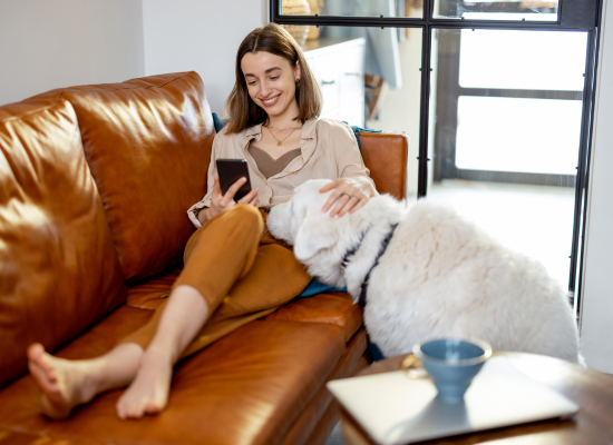 woman lounging on couch with dog